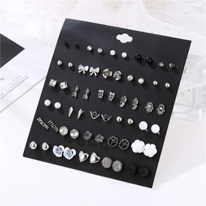 Detail shot of a 30-pair earring set featuring rhinestones and pearls on a display card