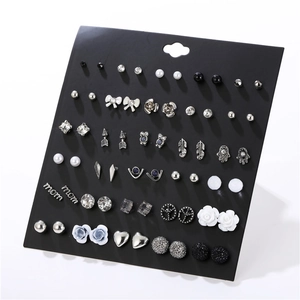 Detail of 30-pair earring set with pearls, rhinestones, and geometric metal studs