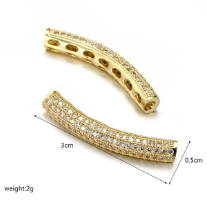 Detailed macro view of 3cm gold-plated brass tube beads with full cubic zirconia stones