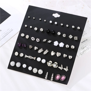 Detailed close-up of 30 pairs mixed earrings set with pearls and rhinestones