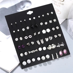 Detail view of 30 pairs earring set featuring pearls, crystals and geometric designs