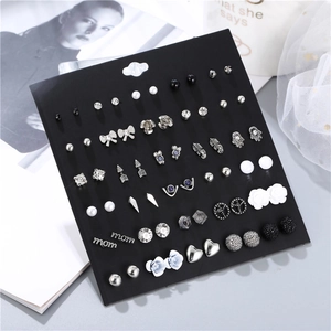 Detail view of 30-pair earring set with pearls and rhinestones on black display card