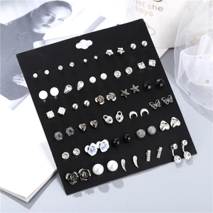 Detailed view of 30 pairs variety pack stud earrings on display card with diverse icons