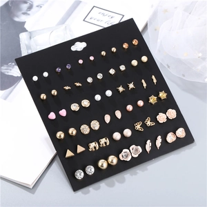 Detailed set of 30 assorted earrings including pearls, crystals, and hearts on display