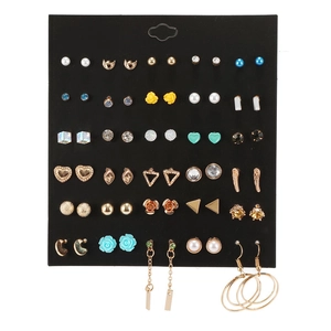 Detail view of 30 pairs of assorted earrings with pearls and crystals on heart display card