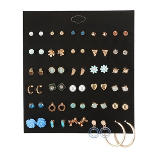 Detailed set of geometric earrings with faux pearls and rhinestones on black display card