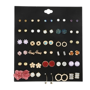 Macro shot of a 30-pair variety set with pearls, rhinestones and metal stud earrings