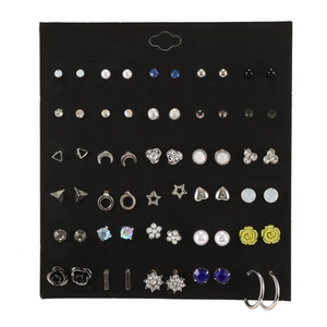 Close-up of a 30-pair fashion earring set with pearls and rhinestones on black board