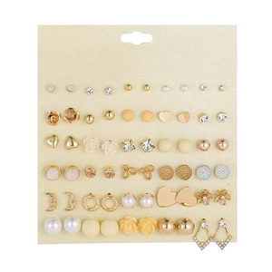 Detailed view of 36 pairs gold earring set featuring pearls, hearts and rhinestones