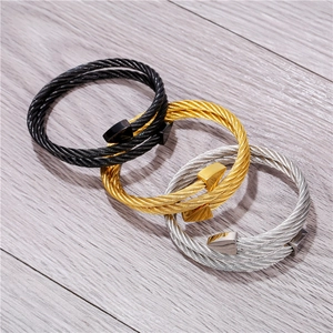 Three-piece stainless steel cable bracelets in black, gold, and silver with triangles
