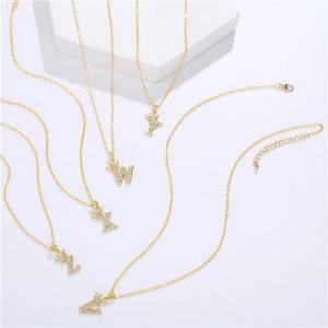 Detail of gold crown letter pendants V-Z with white zircon inlay on delicate chains