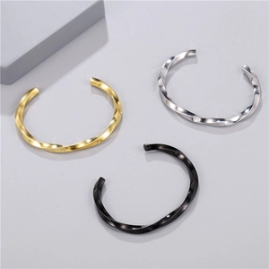 Minimalist twisted C-shape stainless steel cuff bracelet in gold, silver, and black finishes