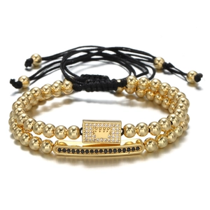 Detail of beaded bracelet set with gold crown emblem and micro-pave zircon rectangular plates