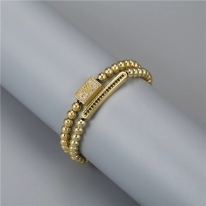 Detailed macro view of gold beaded crown bracelet with micro-paved black and white zircons