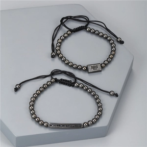 Close-up of men's crown zircon beaded bracelets on modern minimalist geometric stand