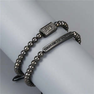 Close-up of men's crown bracelets with micro-paved cubic zirconia and gunmetal beads