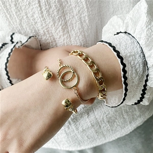 Three-piece gold hip-hop jewelry set featuring a chunky curb chain and skull open bangle