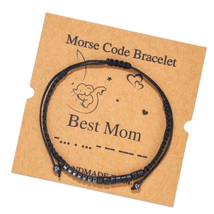 Detail of Morse code bracelet with dark beads on Best Mom Kraft card packaging