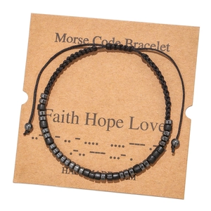 Detail of Morse code bracelet featuring black hematite beads on a kraft card display