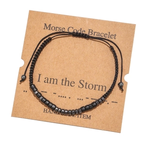 Detail of Morse code bracelet with I am the Storm message on handmade card