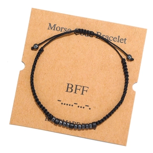 Detail of Morse code bracelet with beads on BFF card packaging with woven rope texture