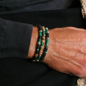Ethnic beaded bracelet set with green malachite and wood beads on a male wrist