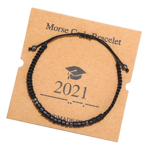 Detail of handmade Morse code bracelet with black beads on a 2021 graduation card