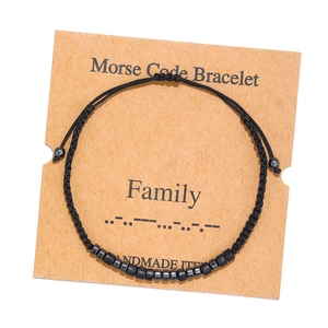 Detail of handmade Morse code bracelet for family on brown kraft display card