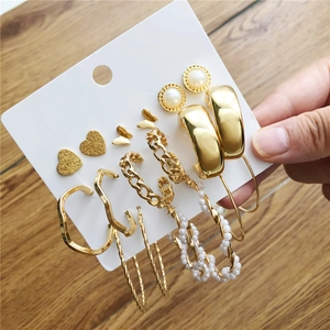 9 pairs of gold geometric pearl heart butterfly hoop earrings set on display card