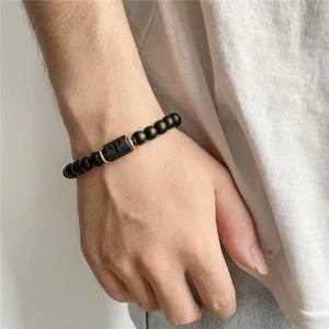 Men's matte black onyx beaded bracelet with gold accents and engraved letter P