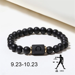 Detail of Libra zodiac bead bracelet with matte black onyx stones and gold spacers