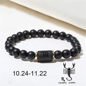 Detailed macro view of Scorpio matte black onyx beaded bracelet with gold spacers