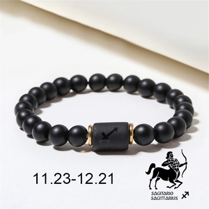 Detailed view of matte black agate beads and Sagittarius zodiac sign cylinder bead