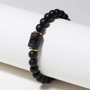 Matte black agate beaded zodiac tiger bracelet with gold spacers on display stand