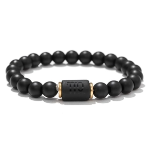 Matte black agate Virgo zodiac stretch bracelet with gold accents on white background