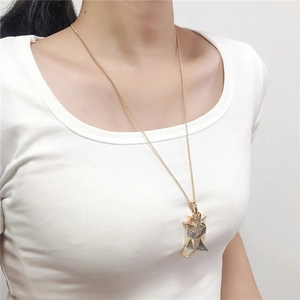 Golden Egyptian queen pendant necklace on male model wearing a white shirt