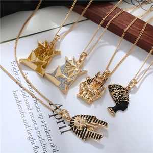Detailed display of Egyptian Pharaoh and Anubis pendants with black enamel finish