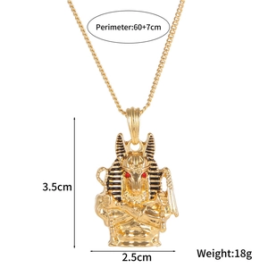 Detailed view of golden Anubis pendant with red gemstone eyes and size dimensions