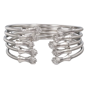 Set of five silver punk fist open bracelets showing detailed metal texture and unique design