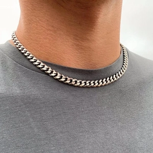 Dettaglio della catena cubana lucida in argento per uomo indossata da un modello su maglia