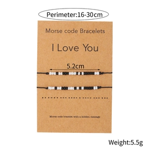 Adjustable Morse Code I Love You bracelets set with black and white beads on a gift card