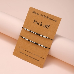 Two-piece Morse Code bead bracelets on a brown gift card with 'Fuck off' message