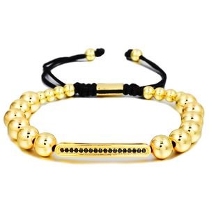 Adjustable woven bracelet with gold beads and a black zircon inlaid bar pendant