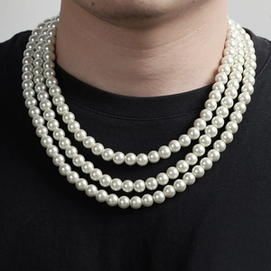 Close-up of triple-layered white pearl necklace on neck showing elegant luster and texture