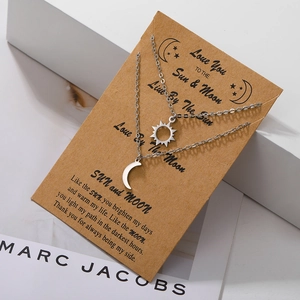 Detail of sun and moon pendant set on sentimental greeting card for couples