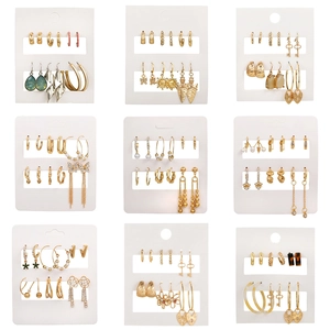9-piece gold alloy earring sets featuring butterflies pearls and heart charms on display