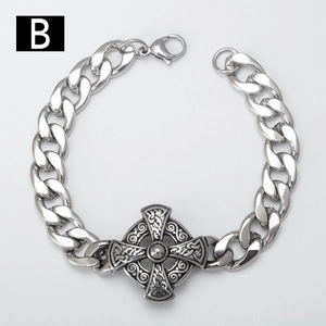 Détail d'un charm croix celtique sur un bracelet à chaîne gourmette de couleur argentée