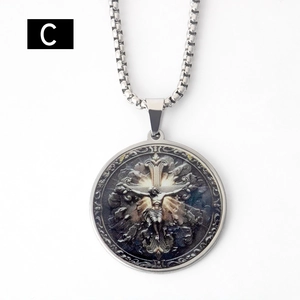 Macro detail of round stainless steel religious pendant featuring Jesus and embossing