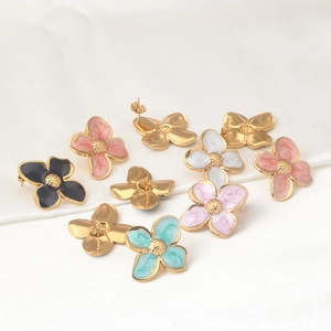 Colorful floral stainless steel stud earrings with enamel finish on white fabric background