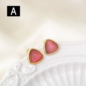Triangle stainless steel stud earrings with pink cat eye stone on silk fabric